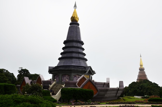 Naphamethinidon chedi and Naphaphonphumisiri pagoda stupa of Doi Inthanon mountain with mist rainning in morning for thai people travelers travel visit at Doi Luang or Ang Ga in Chiang Mai Thailand