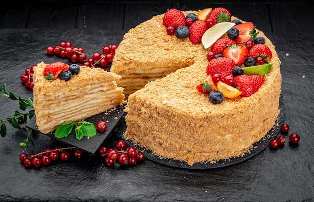 Napoleon cake decorated with berries and fruits