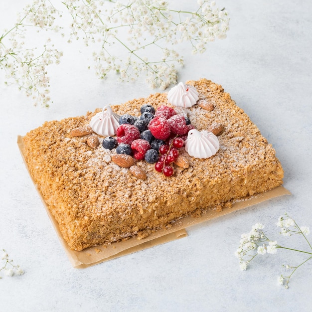 Napoleon cake with butterscotch frosting decorated fresh berries