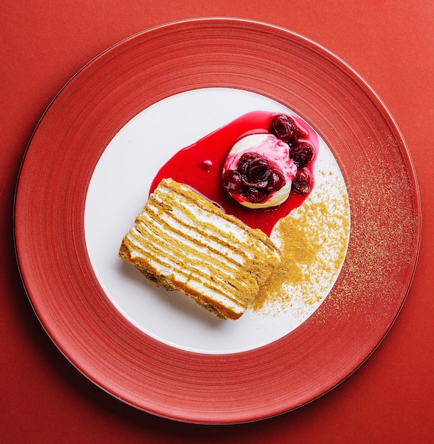 Napoleon cake with vanilla ice cream with cherry jam