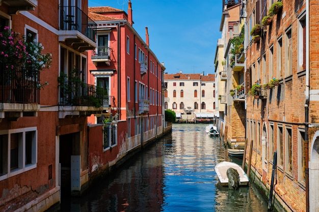 Narrow canal with gondola in Venice, Italy