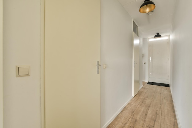 Narrow corridor with doors and lamp