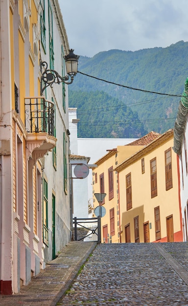 Narrow street or alley between colorful buildings in Santa Cruz de La Palma Bright and vibrant classical architecture in a small city or village Beautiful houses or homes with a vintage design