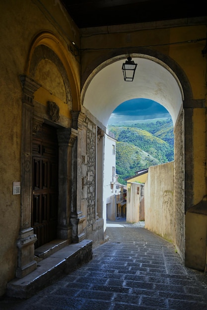 A narrow street between the old houses of Teggiano a medieval village in Campania Italy