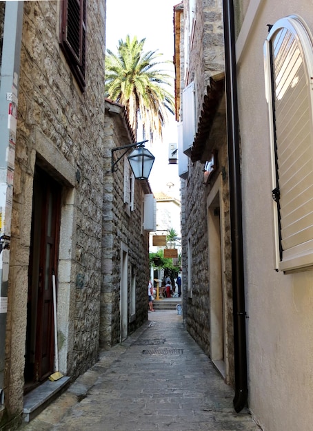 Narrow street in the old medieval town of Budva with Venetian Mediterranean architecture Windows