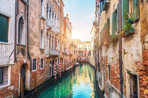 Narrow streets with canals and apartment buildings in Venice Italy