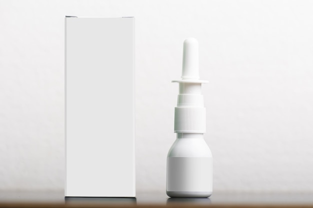 Nasal spray with an empty box on white background