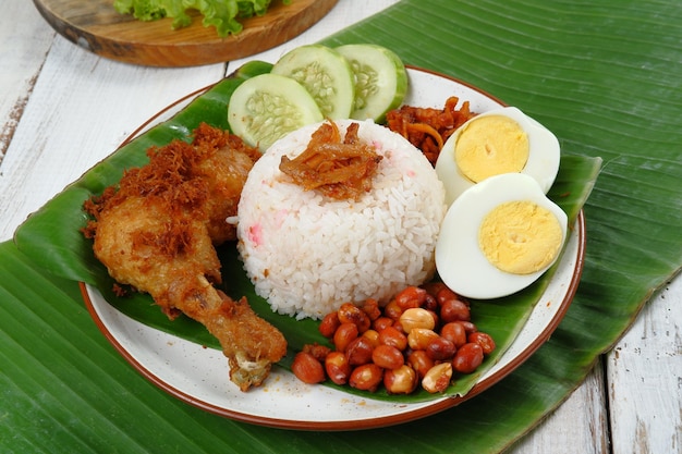 Nasi lemak,Malay fragrant rice dish cooked in coconut milk and pandan leaf.served with various sid