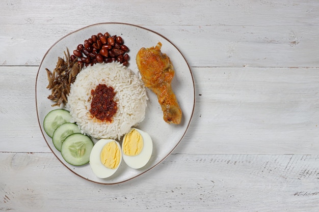 Nasi lemak a traditional malay curry paste rice dish served with variouse side dish