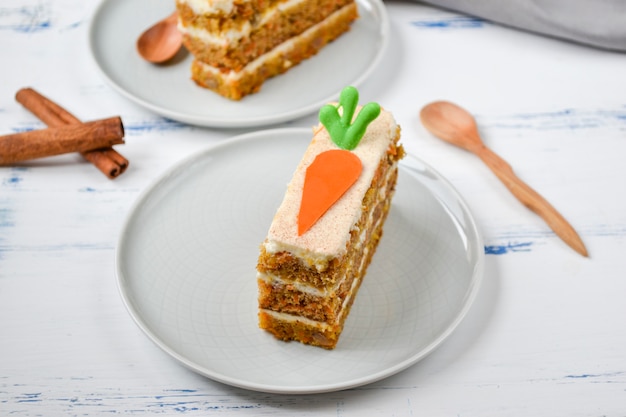 National Carrot Cake Day.  Carrot cake with cream cheese frosting decorated with chocolate carrots