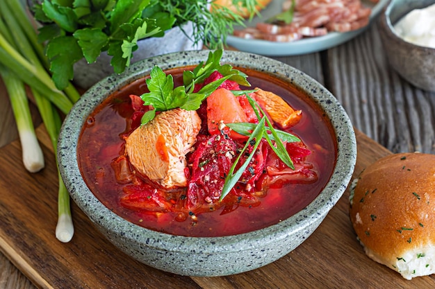 National dish of Ukrainian cuisine borscht with vegetables, turkey meat, herbs, sour cream