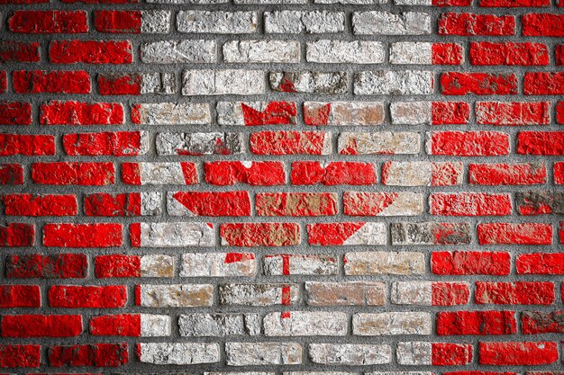 National flag of Canada
 on an old brick wall