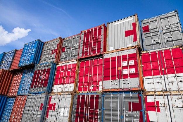 national flag of Georgia on a large number of metal containers for storing goods stacked in rows