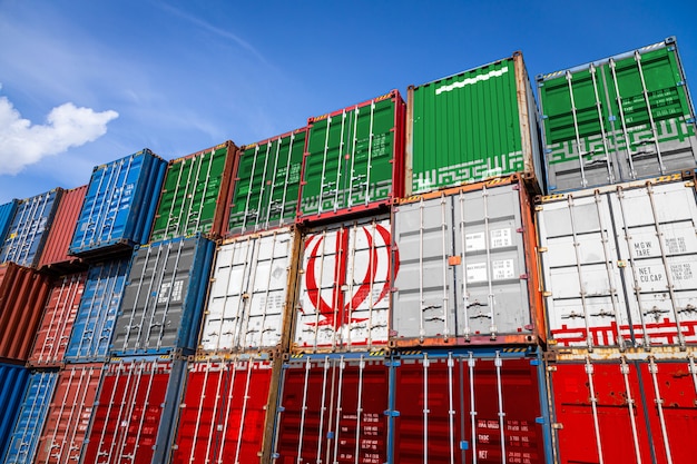 national flag of Iran on a large number of metal containers for storing goods stacked in rows