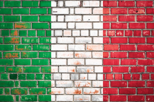 National flag of the Italy on a grunge brick background