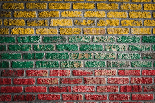 National flag of Lithuania on an old brick wall