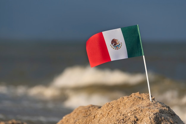 National flag of Mexico on sea. Vacation in Mexico on the beach.