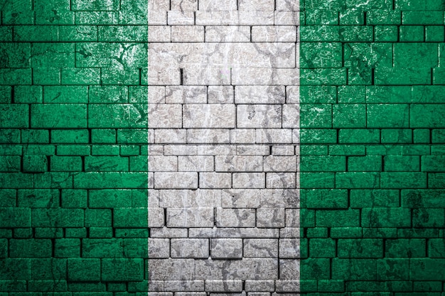 National flag of Nigeria on brick wall background.