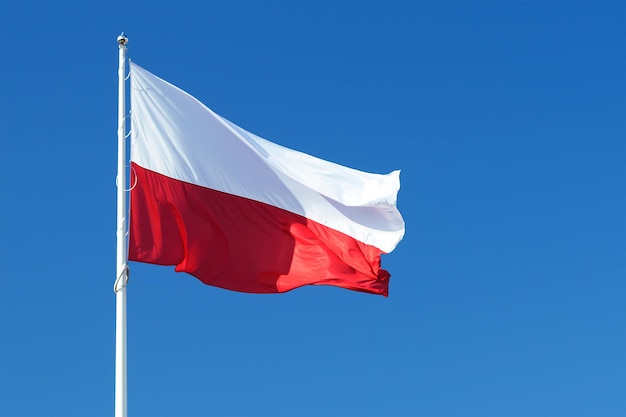 National flag of Poland waving on a clear blue sky background