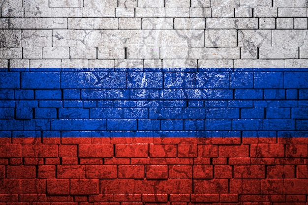 National flag of Russia on brick wall background.