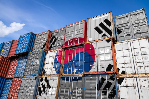 The national flag of South Koreon large number of metal containers for storing goods stacked in rows on top of each other.