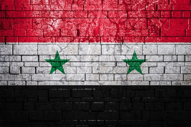 National flag of Syria on brick wall.The concept of national pride and symbol of the country.