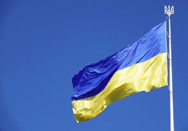 National flag of Ukraine against blue sky