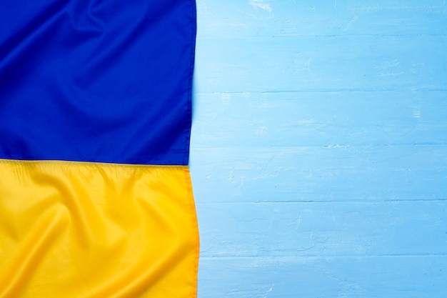 National flag of Ukraine on dark wooden