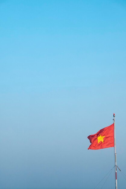 National flag of Vietnam waving with blue sky in the background