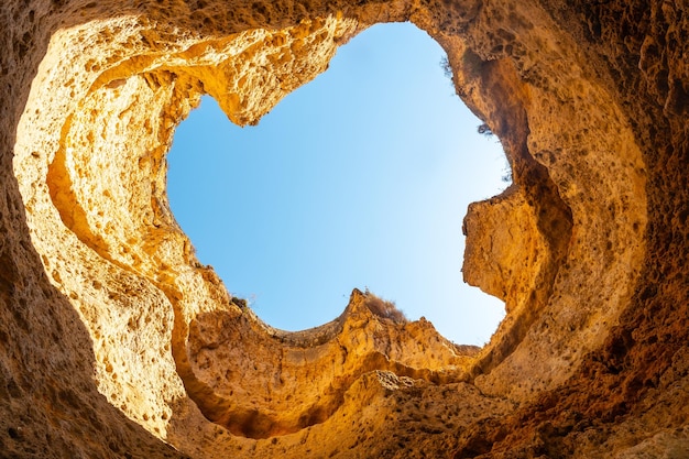 Natural arch or hole on the beach at Praia da Coelha Algarve Albufeira Portugal