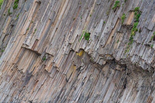 Natural background rock fragment from volcanic lava columns