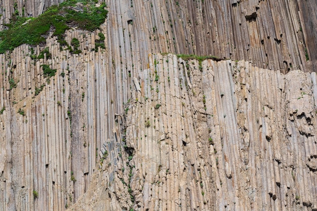 Natural background rock surface formed by vertical basalt columns