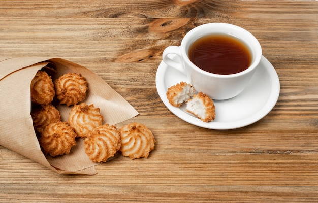 Natural baked coconut cookies or cocoanut macaroons with tea or coffee. Homemade diet biscuits with coco chips