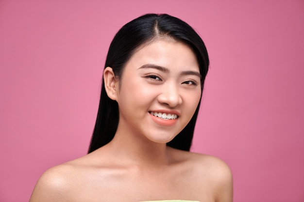 Natural beauty concept of a young Asian woman on a pink background