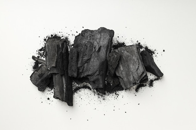 Natural black hardwood charcoal on white background