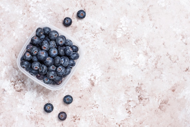 Natural blueberries on light brown background,top view,copy space