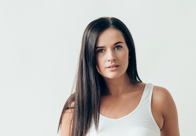 Natural brunette woman long hair casual makeup. Studio shot.