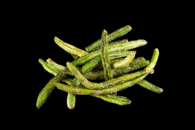 Natural chips of green string beans. Crispy dried vegetables with addition of molasses