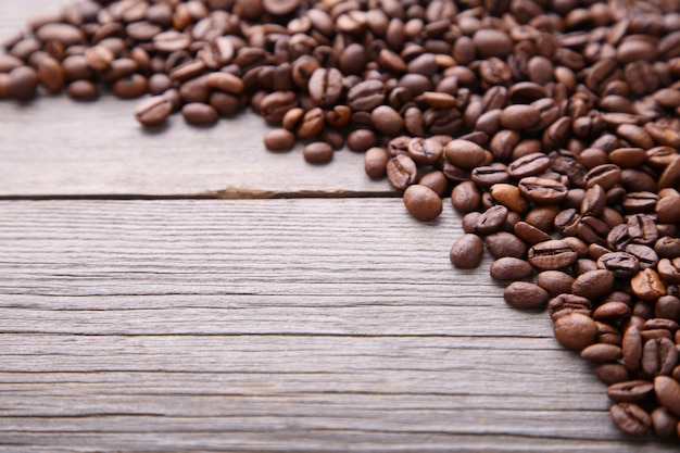 Natural coffee beans on grey wooden table