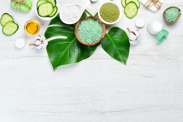 Natural cosmetics from green cucumber on white wooden background The concept of cosmetics and spa Top view Free copy space