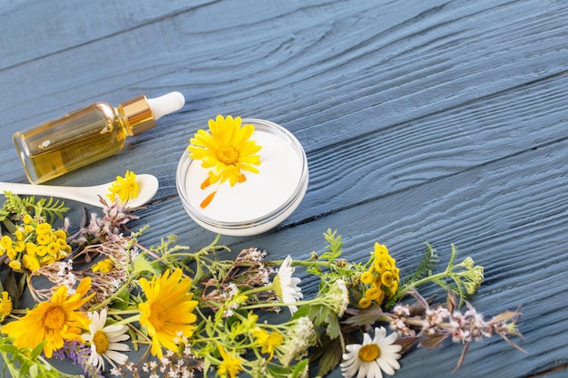 Natural cosmetics from herbal ingredients on blue background