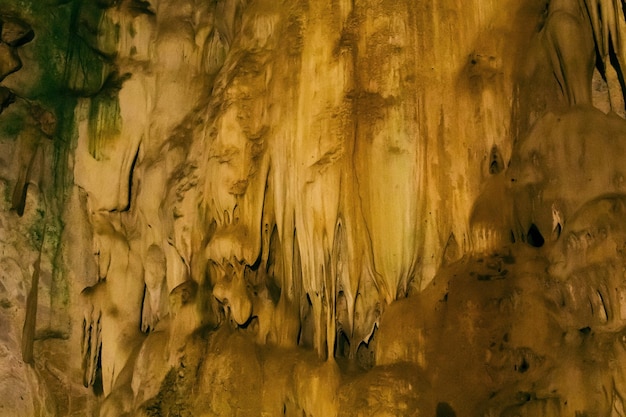 Natural dark underground cave with strangely shaped stalactites