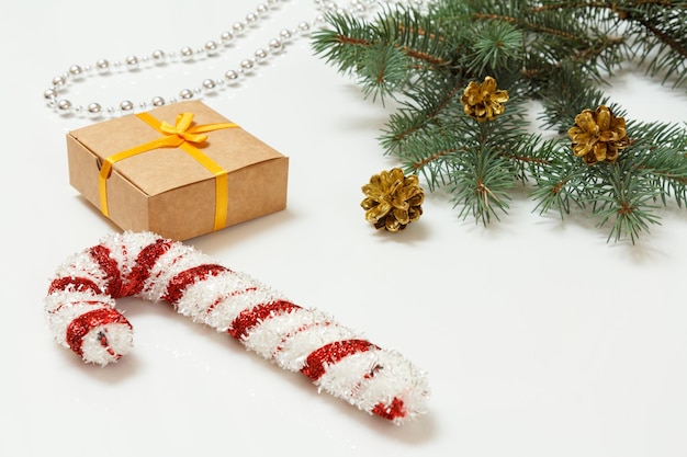 Natural fir tree branch with Christmas ornament on white background