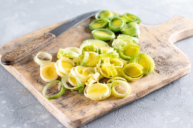 Natural fresh cutted leeks on the wooden cutting board Leek cut by means rings on a chopping board