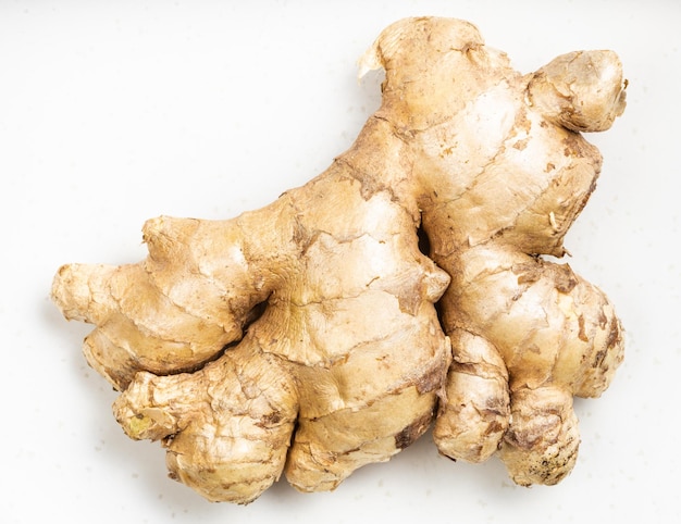 Natural fresh whole ginger root on gray plate