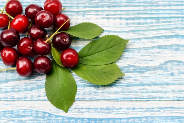 Natural garden cherry berries on a wooden background the concept of natural products without GMO