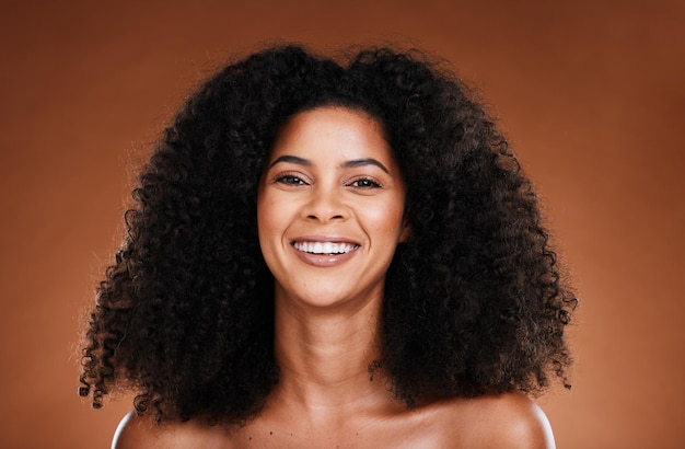 Natural hair care and black woman in studio portrait for wellness beauty and luxury with smile happy for shine or glow results Skin care healthy hair and young model headshot for salon promotion