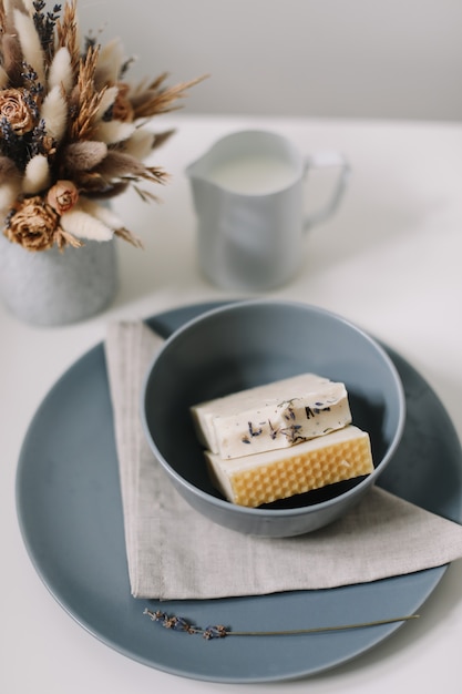 Natural handmade soap with dried slices of oranges on a white surface