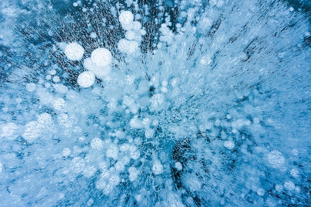 Natural ice bubbles on frozen lake in wintertime