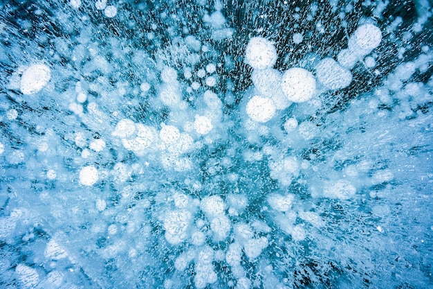 Natural ice bubbles on frozen lake in wintertime